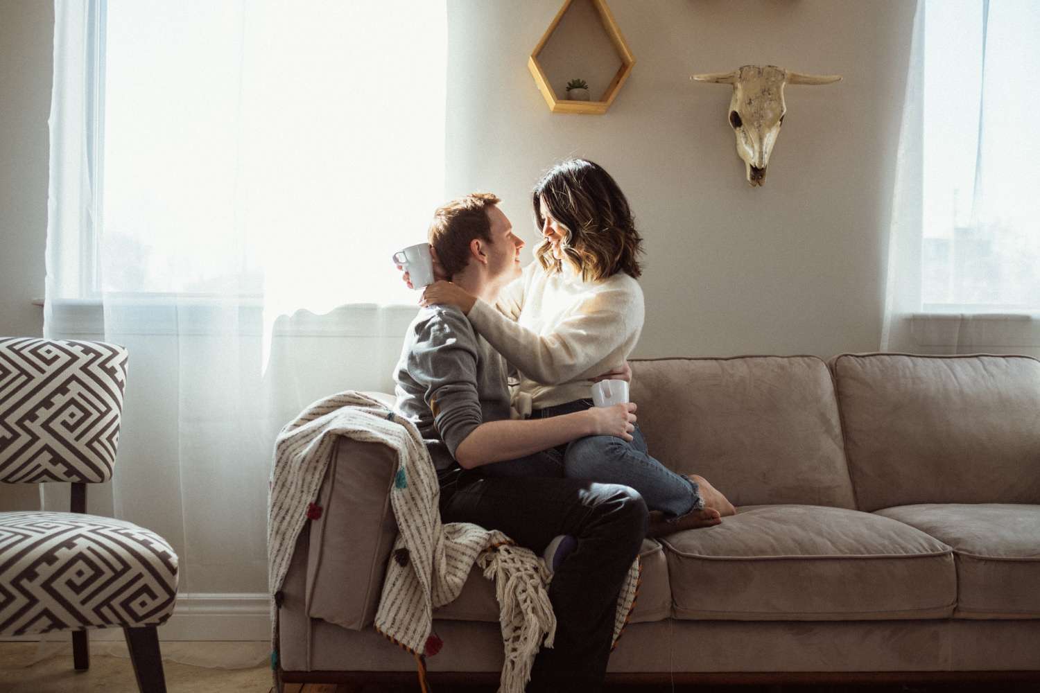 Couple cuddling on the couch during their couples photography session